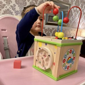 Little Girl Playing With Wooden Activity Cube